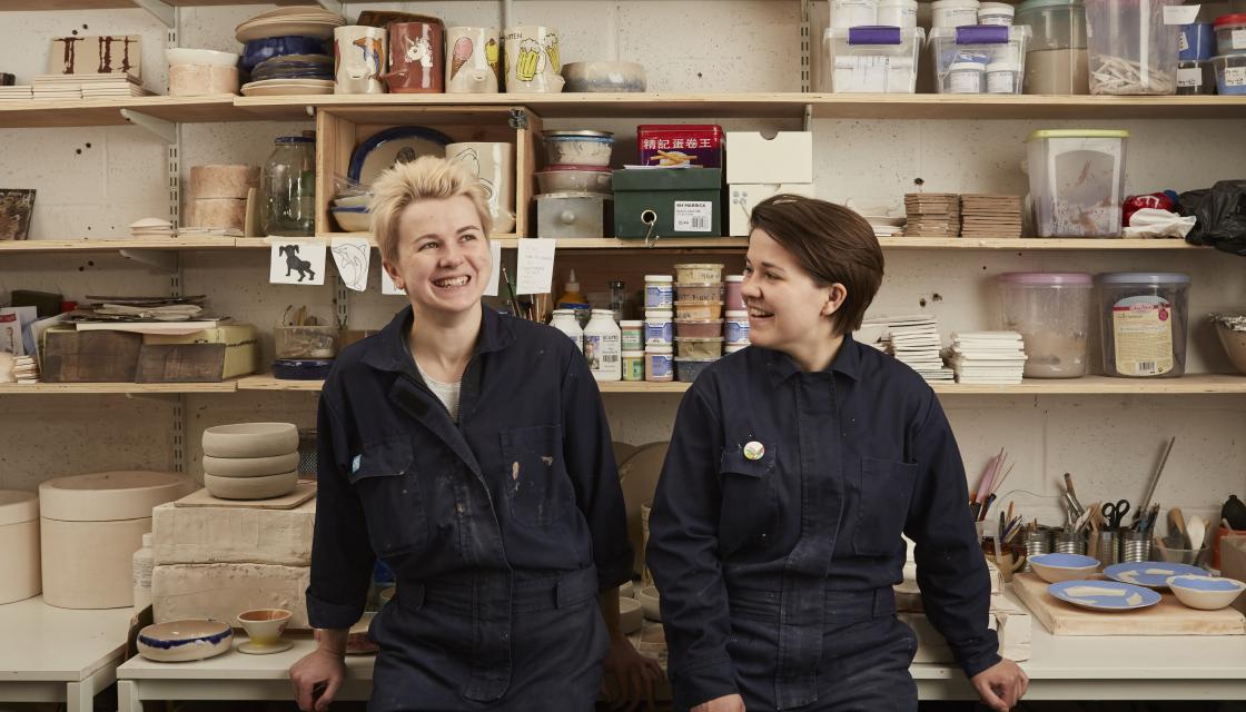 Two potters in workshop