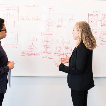 Two colleagues looking at a planning chart