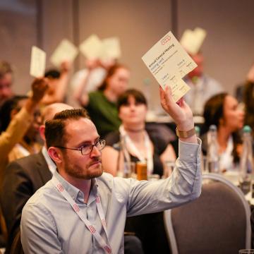 Man voting at annual general meeting