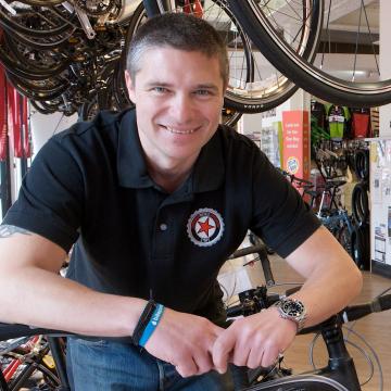 Member of Edinburgh Bicycle Co-op with bikes