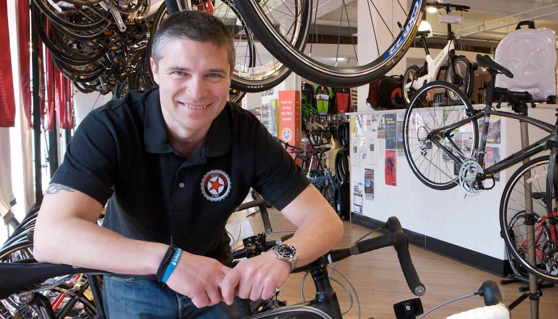 Member of Edinburgh Bicycle Co-op with bikes