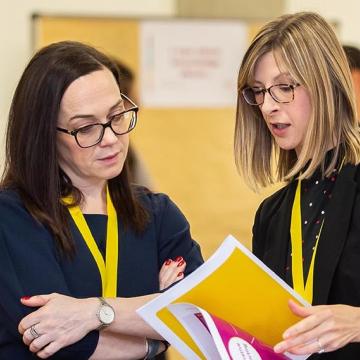 Woman explaining something to another woman