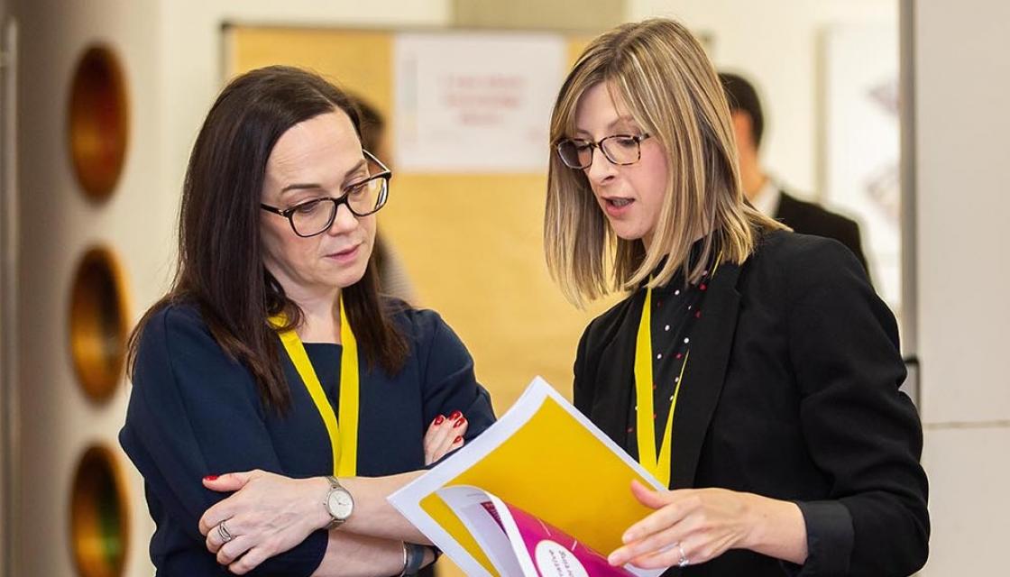 Woman explaining something to another woman