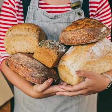 Women holding loaves of bread