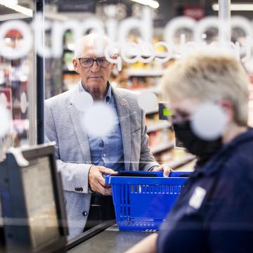 Man being served in a co-op shop