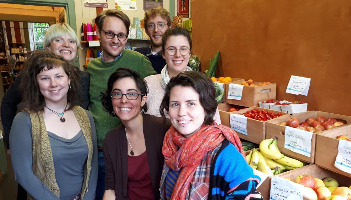 New Leaf co-op members standing in front of fresh fruit display