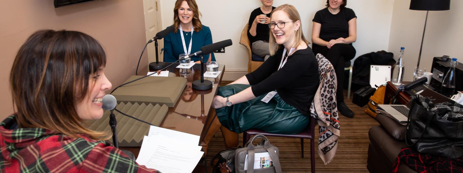 Two women being interviewed for podcast